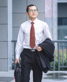 young businessman walking outside office